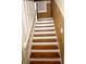 View of wooden stairs with white risers and banister leading to the upper level at 3601 N Kenwood Ave, Indianapolis, IN 46208