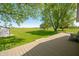 Backyard with a wooden deck and mature trees, perfect for relaxation and enjoying the outdoors at 403 N Red Gold Dr, Trafalgar, IN 46181