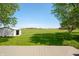 Backyard with a wooden deck and lush lawn, providing a serene outdoor retreat at 403 N Red Gold Dr, Trafalgar, IN 46181