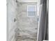 Beautifully tiled shower with modern fixtures and a frosted window at 403 N Red Gold Dr, Trafalgar, IN 46181