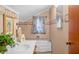 Bathroom featuring a classic sink, bathtub, and framed mirror at 403 N Red Gold Dr, Trafalgar, IN 46181
