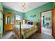 Cozy bedroom with wood furnishings, floral bedding, and a large window offering a serene view at 403 N Red Gold Dr, Trafalgar, IN 46181