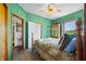 Charming bedroom featuring bright green walls, wood accents, and a window with a scenic view at 403 N Red Gold Dr, Trafalgar, IN 46181