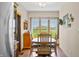 Bright dining area with natural lighting, wood table, and a clear view of the outside landscape at 403 N Red Gold Dr, Trafalgar, IN 46181