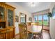 Bright dining room featuring a wooden table with chairs and a large window overlooking a green field at 403 N Red Gold Dr, Trafalgar, IN 46181