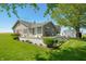 Charming home featuring a welcoming deck and lush landscaping at 403 N Red Gold Dr, Trafalgar, IN 46181