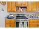 Close up view of a gas cooktop, wooden cabinets, and light countertops in kitchen at 403 N Red Gold Dr, Trafalgar, IN 46181