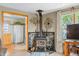Comfortable living room featuring a wood-burning stove, ample natural light, and views into the kitchen at 403 N Red Gold Dr, Trafalgar, IN 46181