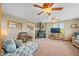 Inviting living room with a cozy wood-burning stove, comfortable seating, and ample natural light at 403 N Red Gold Dr, Trafalgar, IN 46181