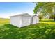 A white outbuilding in the yard at 403 N Red Gold Dr, Trafalgar, IN 46181