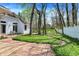 Backyard featuring a brick patio, lush lawn, and a white fence for privacy and charm at 424 Orchard Blvd, Danville, IN 46122