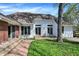 Picturesque backyard featuring lush greenery, brick patio, and well-maintained landscaping at 424 Orchard Blvd, Danville, IN 46122