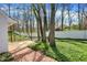Landscaped backyard features a white picket fence, mature trees, and a brick-paved path at 424 Orchard Blvd, Danville, IN 46122