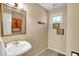 Cozy half bath features classic pedestal sink, decorative mirror, and charming wall decor at 424 Orchard Blvd, Danville, IN 46122