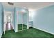 Clean bedroom features green carpet, blue walls, mirrored closet, and shelf at 424 Orchard Blvd, Danville, IN 46122