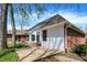 Home exterior showcasing a brick and white facade, beautiful yard, and inviting patio area at 424 Orchard Blvd, Danville, IN 46122
