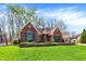 Charming brick home featuring manicured lawn, flowering shrubs, and classic architectural details at 424 Orchard Blvd, Danville, IN 46122