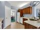 Galley-style kitchen showing wood cabinets, white countertops, appliances, and access to the breakfast area at 424 Orchard Blvd, Danville, IN 46122