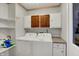 Functional laundry room with white washer and dryer, overhead cabinets, and ample storage at 424 Orchard Blvd, Danville, IN 46122