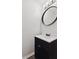 Cozy powder room features a round mirror, a modern vanity, and neutral wall color at 4464 Four Seasons Cir, Indianapolis, IN 46226