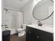 Clean bathroom with a shower-tub combo, a vanity with a round mirror, and modern finishes at 4464 Four Seasons Cir, Indianapolis, IN 46226