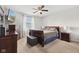 Comfortable bedroom with a wooden sleigh bed, soft carpet, and a window with natural light at 4464 Four Seasons Cir, Indianapolis, IN 46226