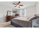 Bright bedroom with wooden furniture, a ceiling fan, and a wall-mounted television at 4464 Four Seasons Cir, Indianapolis, IN 46226