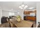 Open-concept layout featuring a dining area with a dark wood table and modern lighting at 4464 Four Seasons Cir, Indianapolis, IN 46226