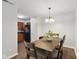 Inviting dining room with a chandelier, a wooden table, and four chairs at 4464 Four Seasons Cir, Indianapolis, IN 46226