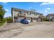 Multi-Gathering unit with garage parking, a well-maintained lawn, and charming wooden balconies overlooking a blue car at 4464 Four Seasons Cir, Indianapolis, IN 46226