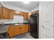 Compact kitchen featuring dark countertops, brown cabinets and modern appliances at 4464 Four Seasons Cir, Indianapolis, IN 46226