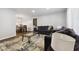 This comfortable living room opens to a dining space featuring a dark wooden table at 4464 Four Seasons Cir, Indianapolis, IN 46226