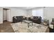 Bright living room featuring stylish sofas, a glass coffee table, and wood floors at 4464 Four Seasons Cir, Indianapolis, IN 46226