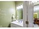 Well-lit half bathroom featuring a decorative mirror and fresh white vanity at 4541 Greenthread Ct, Zionsville, IN 46077