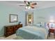 Bright bedroom featuring a ceiling fan, neutral walls, and a large window at 4541 Greenthread Ct, Zionsville, IN 46077