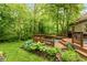 Multi-tiered wooden deck with outdoor seating and lush landscaping at 4541 Greenthread Ct, Zionsville, IN 46077