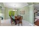 Charming dining room with wood table and chairs, and a scenic backyard view at 4541 Greenthread Ct, Zionsville, IN 46077