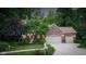 Charming brick home with a well-manicured lawn, mature trees, and a spacious driveway leading to a two-car garage at 4541 Greenthread Ct, Zionsville, IN 46077