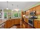 Spacious kitchen featuring stainless steel appliances, hardwood floors, granite countertops, and a breakfast nook at 4541 Greenthread Ct, Zionsville, IN 46077