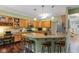 Well-lit kitchen with an island, seating, and custom wooden cabinetry at 4541 Greenthread Ct, Zionsville, IN 46077