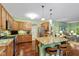 Open kitchen with island seating, granite counters, and stainless steel appliances at 4541 Greenthread Ct, Zionsville, IN 46077