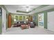 Inviting living room features a tray ceiling, neutral carpet, and is bathed in natural light at 4541 Greenthread Ct, Zionsville, IN 46077