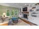 Cozy living room with stone fireplace, built-in shelves, and comfortable seating at 4541 Greenthread Ct, Zionsville, IN 46077
