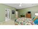 Comfortable primary bedroom showcasing a colorful bedspread and seamless access to the ensuite bathroom at 4541 Greenthread Ct, Zionsville, IN 46077