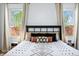 This bedroom shows large windows with views, stylish decor, and a decorative bed at 4622 W 400 S, Trafalgar, IN 46181
