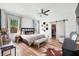 The main bedroom features hardwood floors, a ceiling fan, and a barn door leading to a closet at 4622 W 400 S, Trafalgar, IN 46181