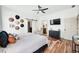 The main bedroom features hardwood floors, a ceiling fan, and a barn door leading to the bathroom at 4622 W 400 S, Trafalgar, IN 46181