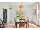 Bright dining room features wood floors, modern lighting, and views of the backyard at 4622 W 400 S, Trafalgar, IN 46181