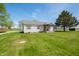 Scenic view of the charming single-story house with a well-manicured green lawn at 4622 W 400 S, Trafalgar, IN 46181