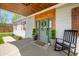 Charming front door with wooden trim, wreath, potted plants, and welcome mat at 4622 W 400 S, Trafalgar, IN 46181